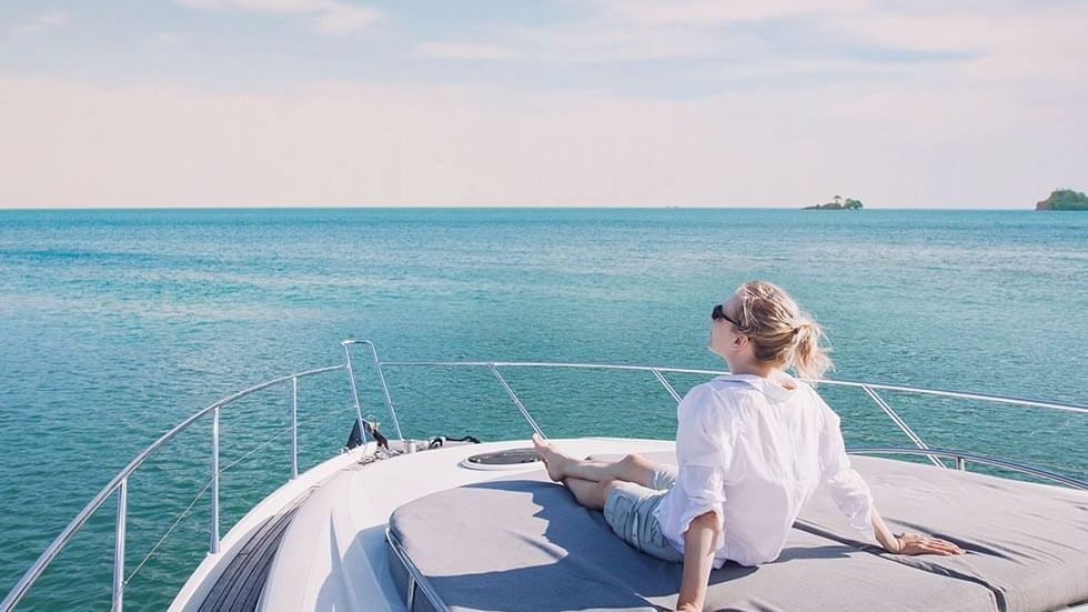 A lady relaxing on a Yacht near Falkensteiner Hotels