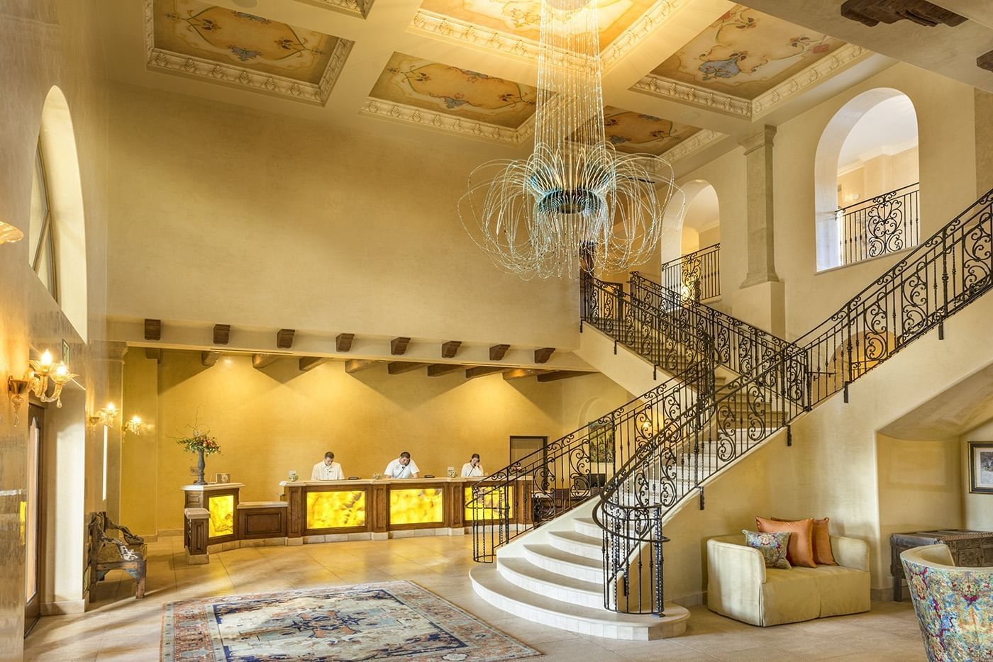 The resorts two story lobby with a center staircase and large ch