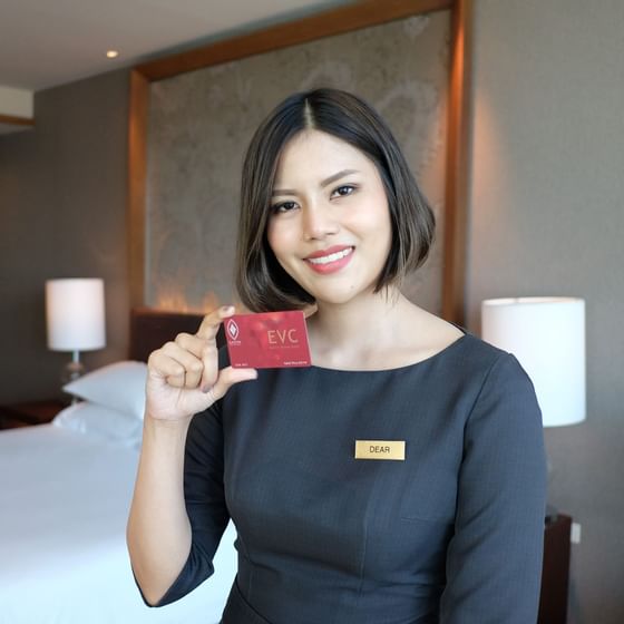 Female staff member holding EVC card at Eastin hotel