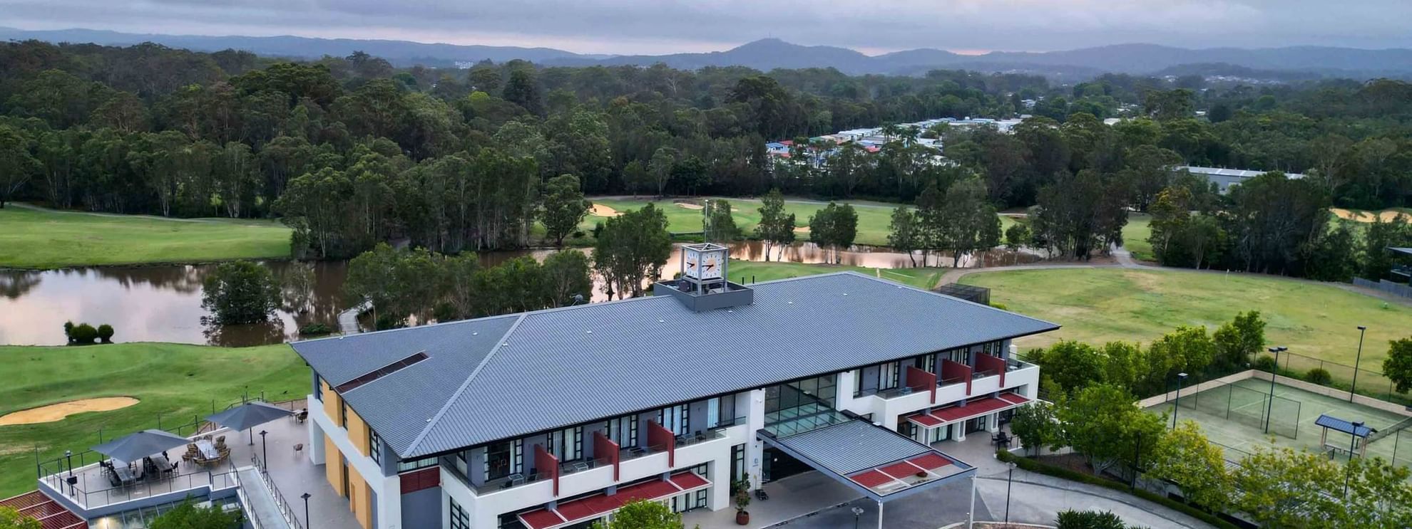 Aerial view of Mercure Kooindah Waters with a central pathway, flanked by green lawns and trees