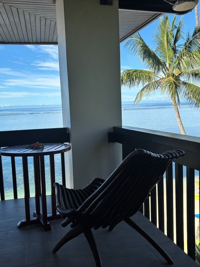 Two lounge chairs and a table on a balcony with ocean view at Warwick Fiji Resort and Spa, Korolevu.