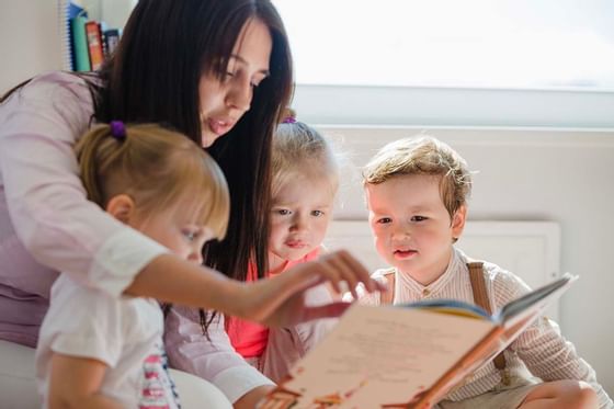 A lady reading a book for children at Buenaventura Grand Hotel