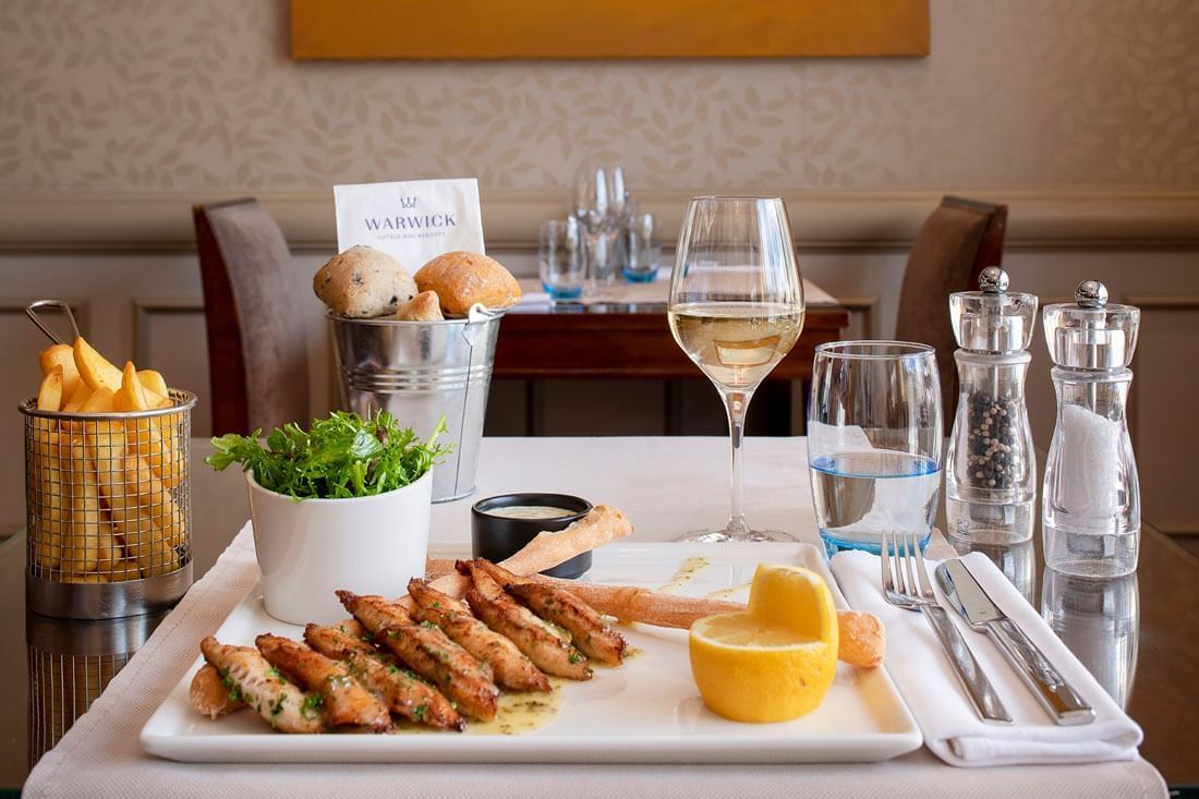 Chef specials' Lake's perch fillets served with fries & a glass of wine at Téséo Restaurant in Geneva