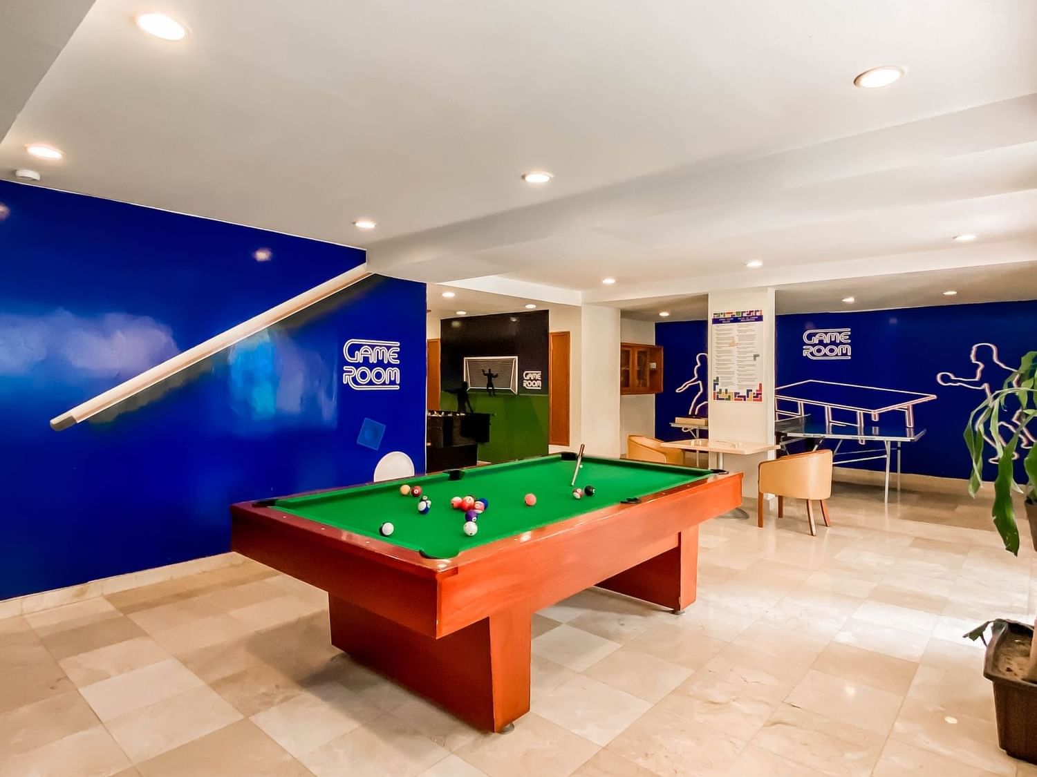 Interior view of the Game Area with a pool table at Plaza Pelicanos Grand Beach Resort