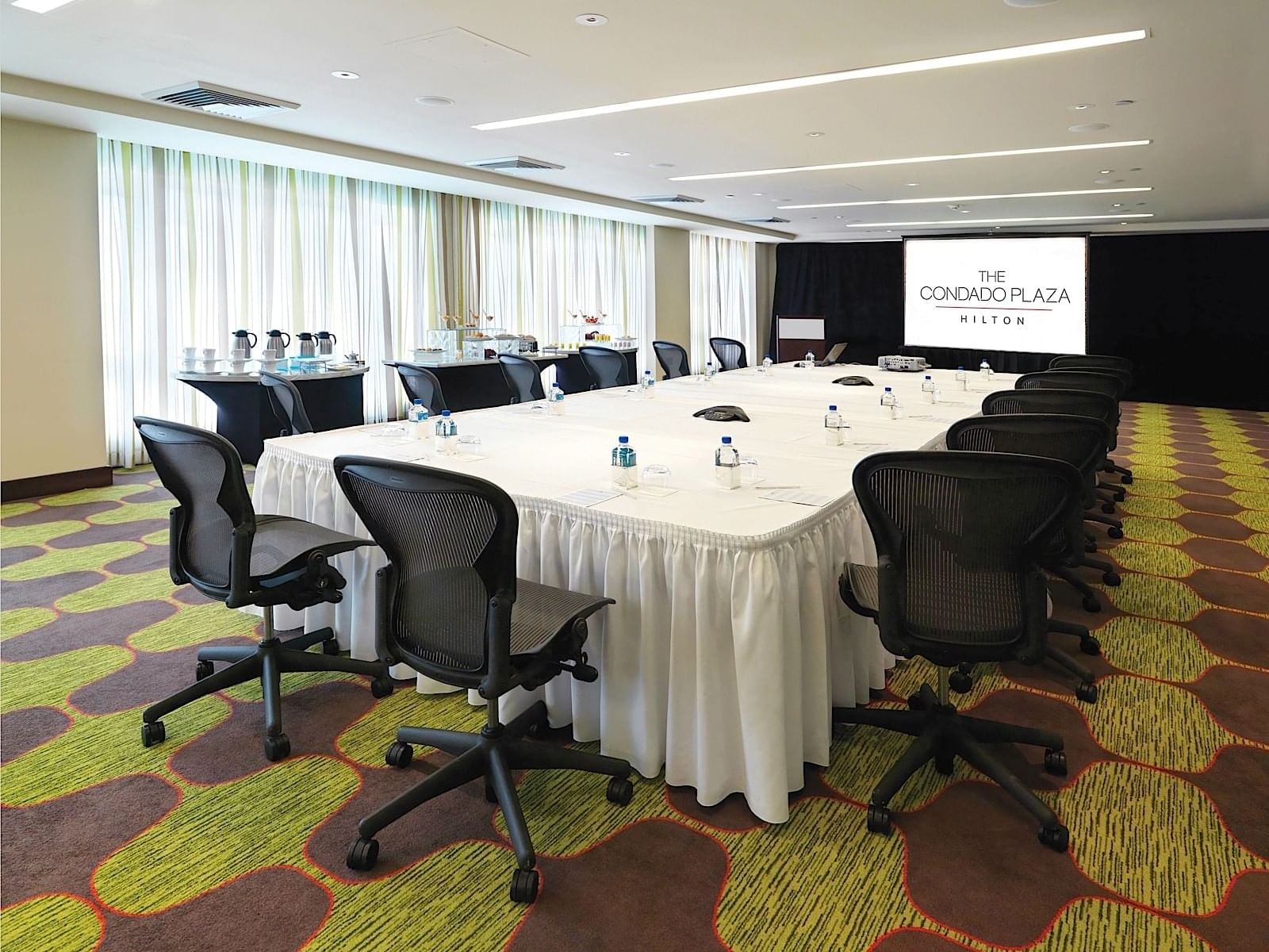 table with chairs and presentational screen at Laguna Room