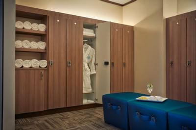 a robe and towels in a closet