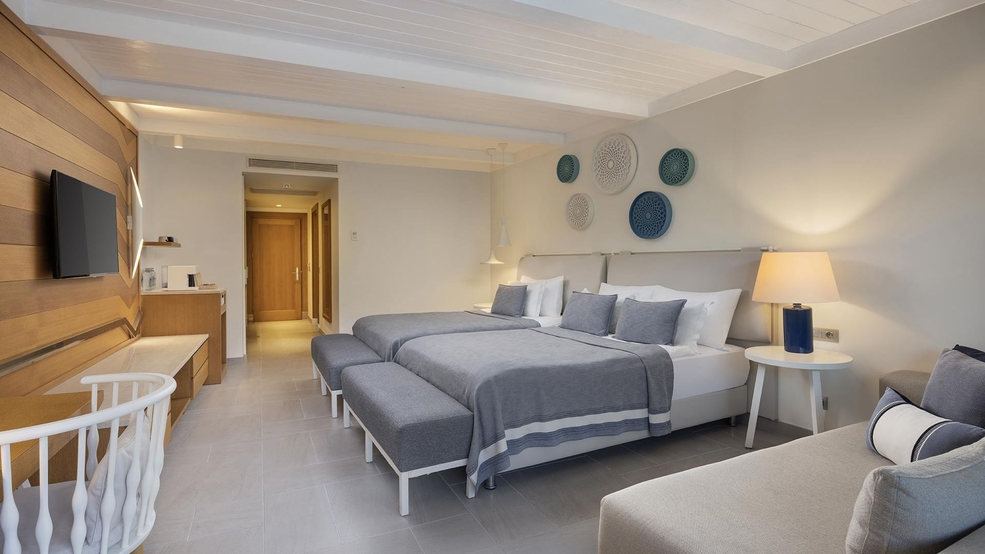 Spacious Swim-up Superior room with large beds, seating area, and decorative wall art.