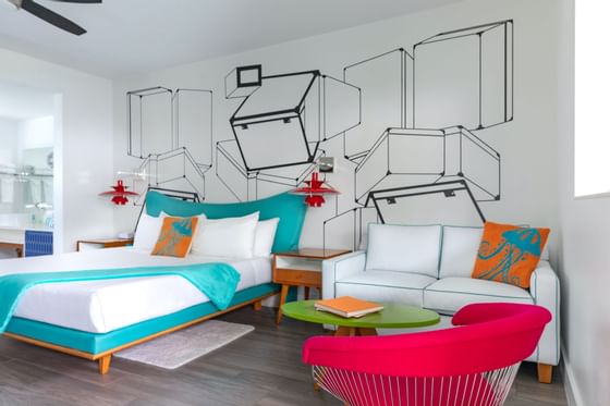 Image of the King size bed and couch in the Electra Deluxe room