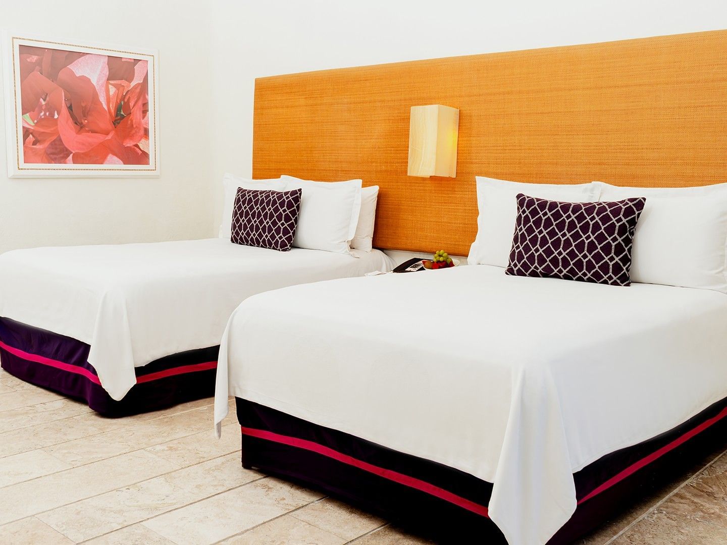 Nightstand by the beds with cushioned headboard and wall art in Two Double Deluxe at Camino Real Zaashila Huatulco