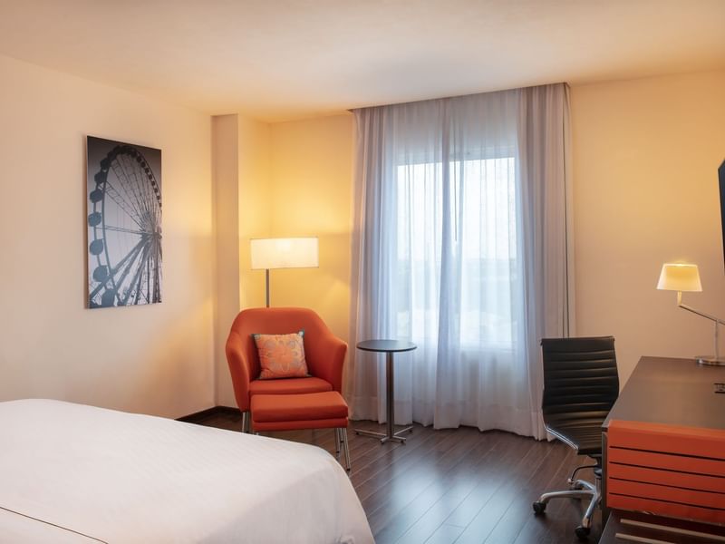 Bed, lounge & work desk in Accessible Room at Fiesta Inn