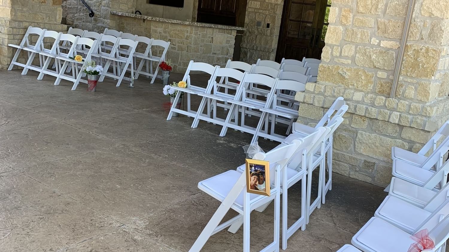 Outdoor setting of North Patio featuring rows of white folding chairs at Shangri-La Monkey Island
