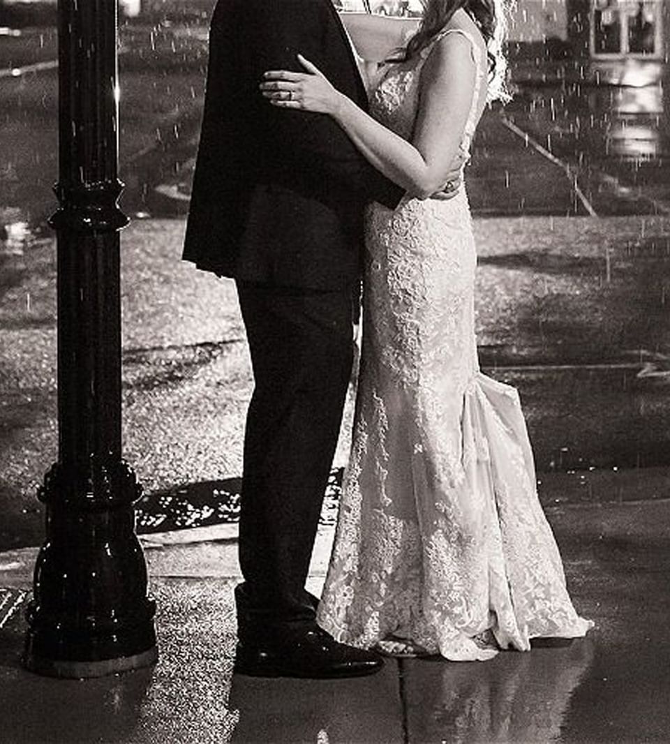 Black & white portrait of wedded couple under the rain near Inn at the Crossroads