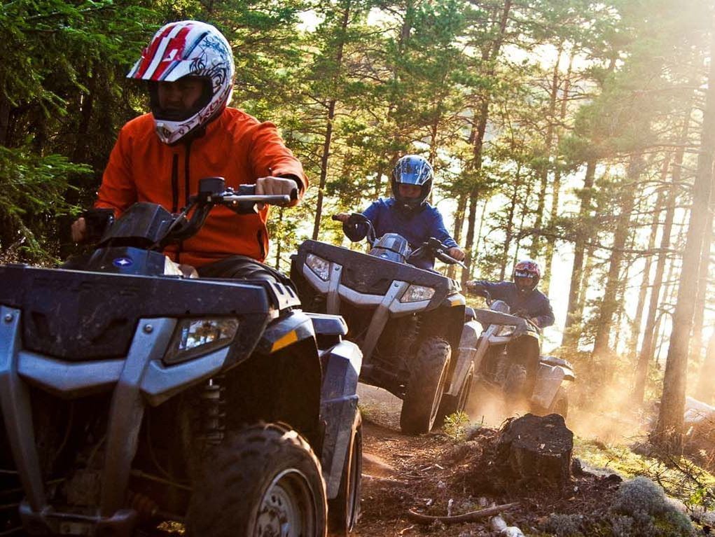 A group of people riding ATVs near The Chateaux Deer Valley