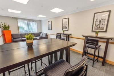 Stuart Room meeting space at The Aberdeen Altens Hotel with a large table and a comfortable grey sofa