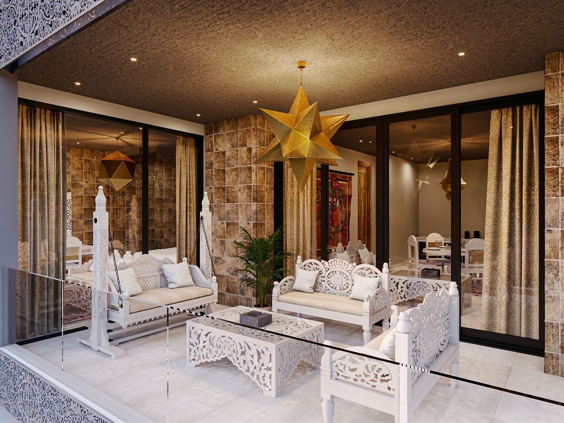A balcony with white furniture, a glass table, and a gold star hanging from the ceiling.