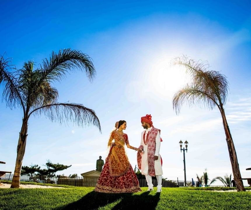 South Asian wedding couple with Palm trees, Ocean Place Resort