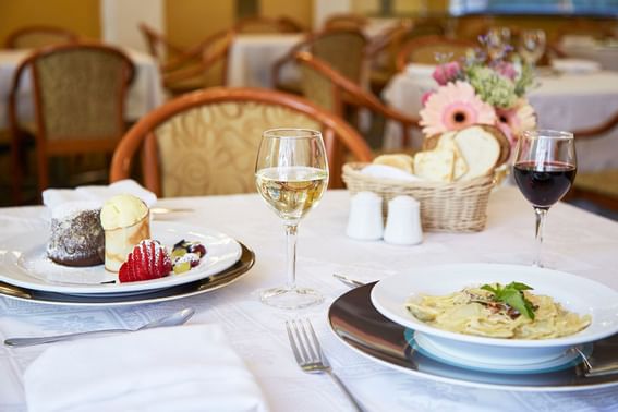 Dining table setup with served dishes at Hotel Torremayor Lyon