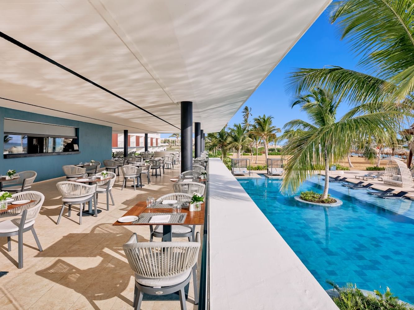 Restaurant style dining tables arranged in Huzur by the pool at Live Aqua Resorts and Residence Club