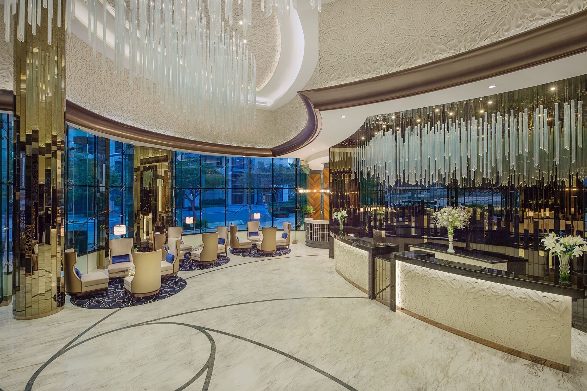Elegant lobby with hanging glass chandelier & seating area at DAMAC Maison Distinction