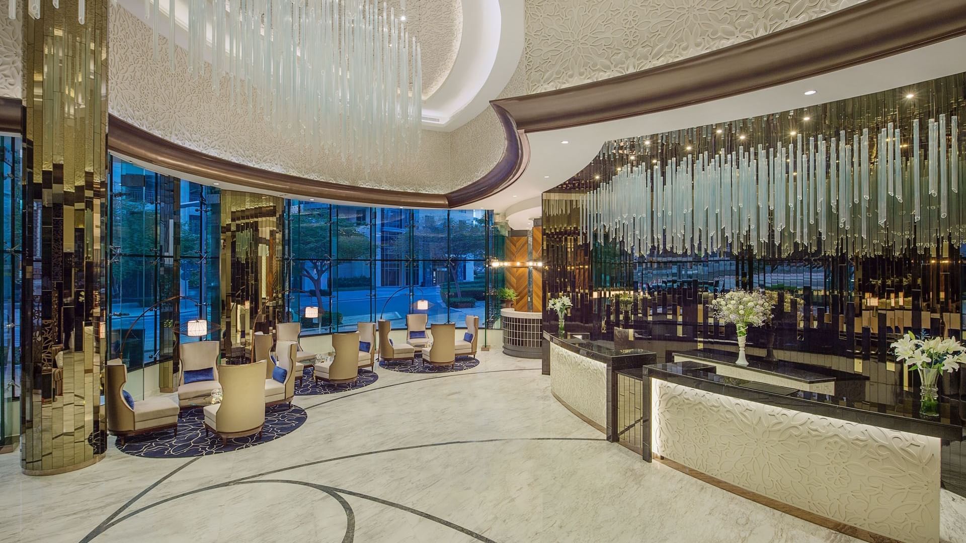 Spacious lobby lounge area with welcome receptionist counter at DAMAC Maison Distinction