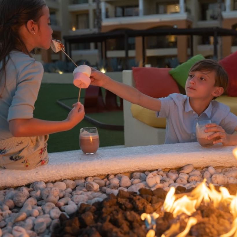 Portrait of kids by the fire at Casa Dorada Los Cabos