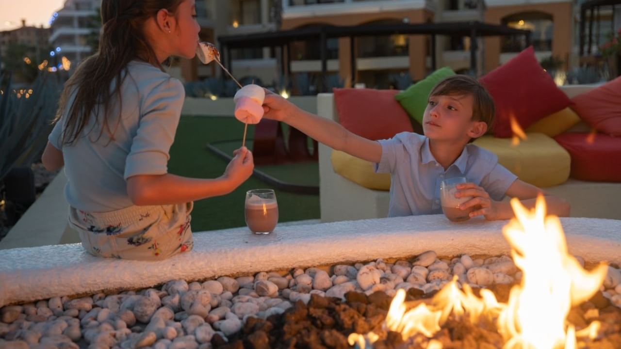 Portrait of kids by the fire at Casa Dorada Los Cabos