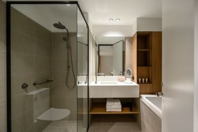 Bathtub shower & vanity area in a Room at Nesuto Docklands