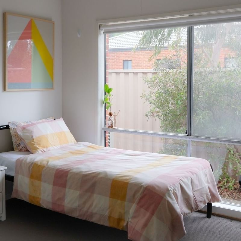 Comfortable bedroom with single bed, desk, and large window at La Trobe University Regional Housing - Ballarat.