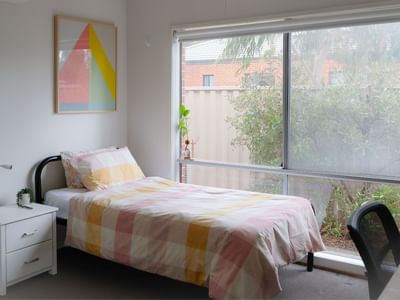 Comfortable bedroom with single bed, desk, and large window at La Trobe University Regional Housing - Ballarat.