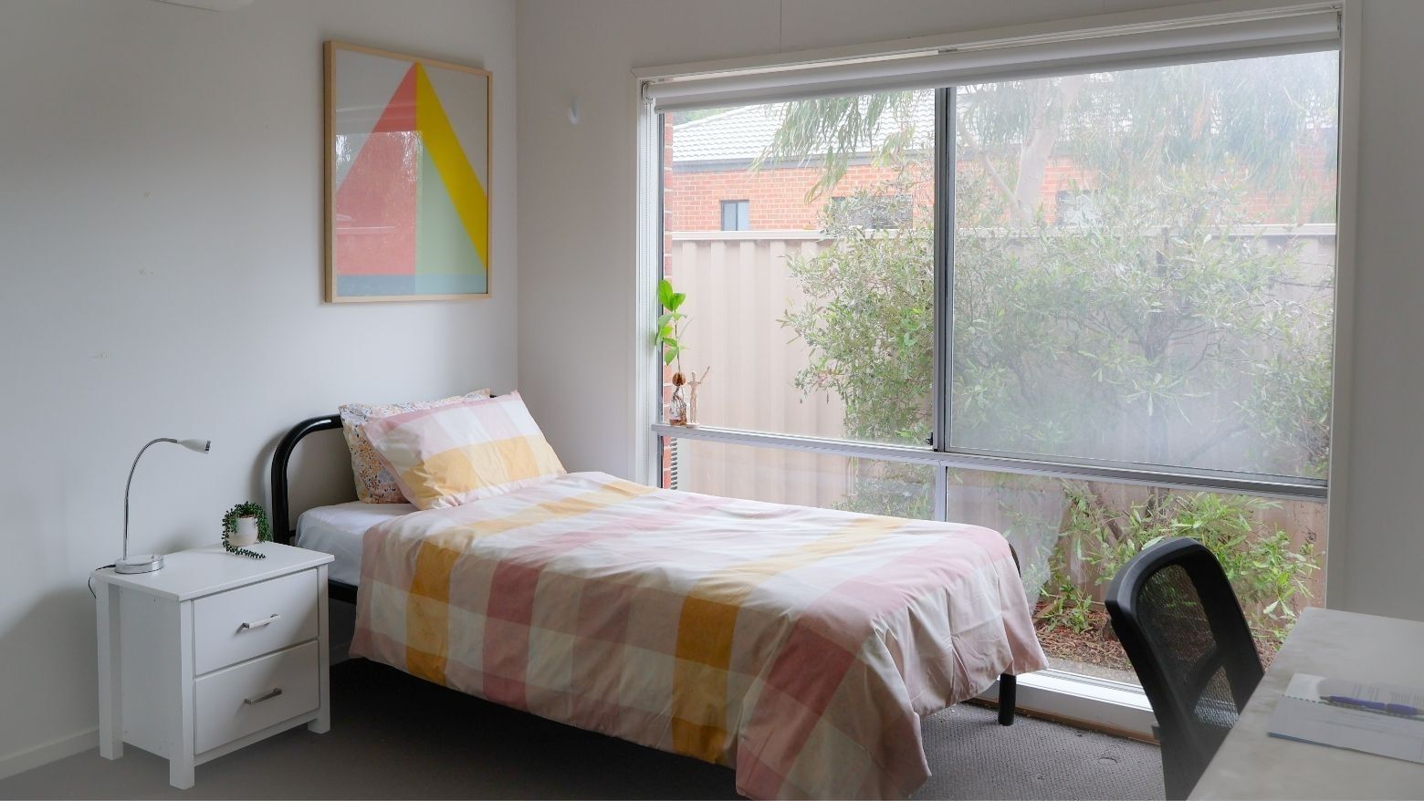 Comfortable bedroom with single bed, desk, and large window at La Trobe University Regional Housing - Ballarat.