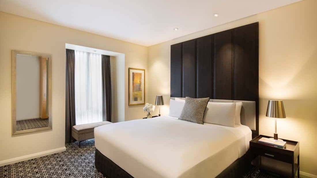 Large bed & lamps in Prestige Suite at Sofitel Sydney Wentworth
