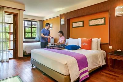 Premium water chalet with wooden flooring and guests settling in - Lexis Port Dickson