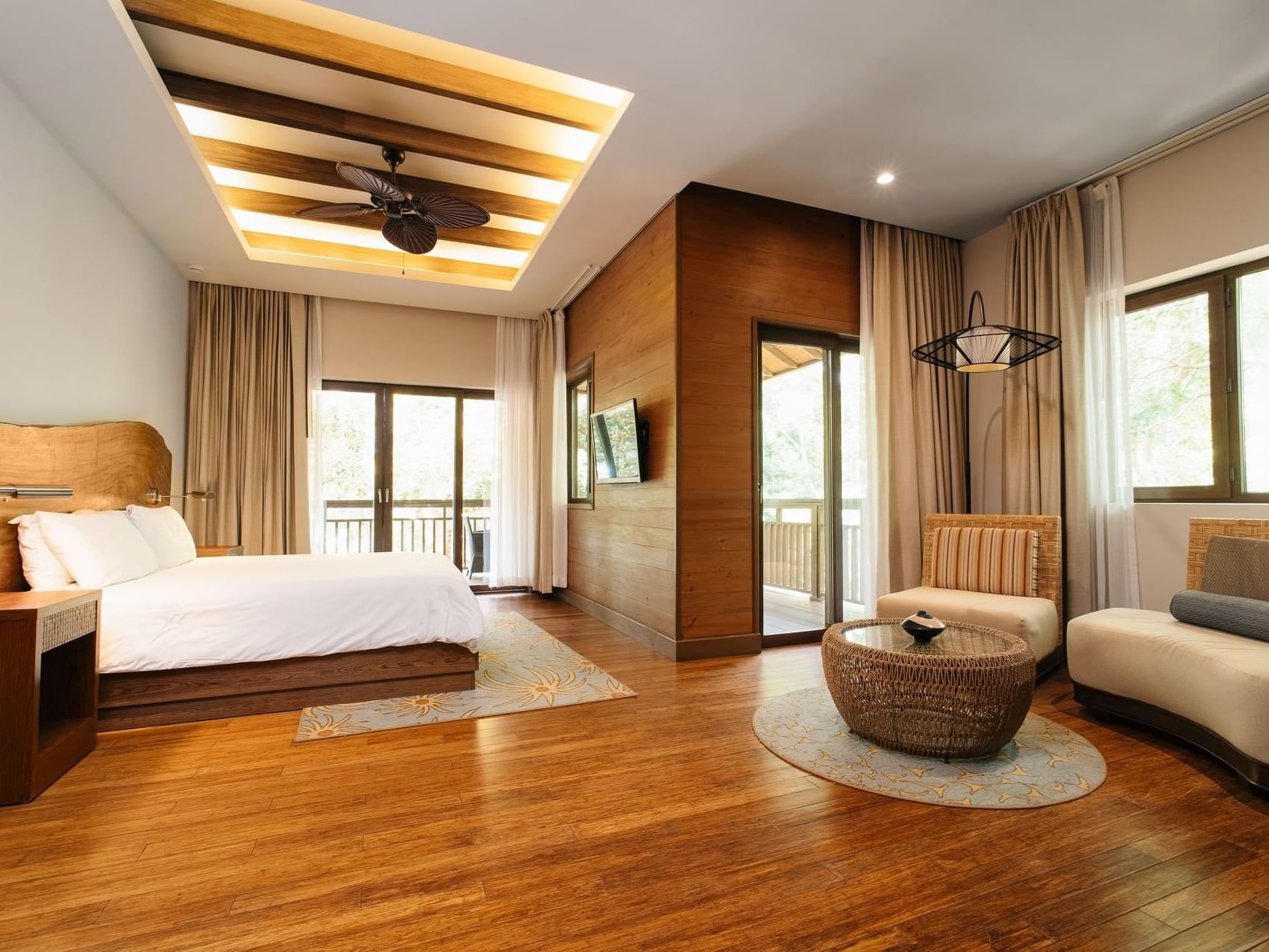 Seating area & TV by the bed in Ocean View 1 King Bed Junior Suite at Indura Beach & Golf Resort