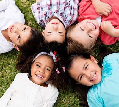 A group of kids laying down on the ground at Mundo Imperial