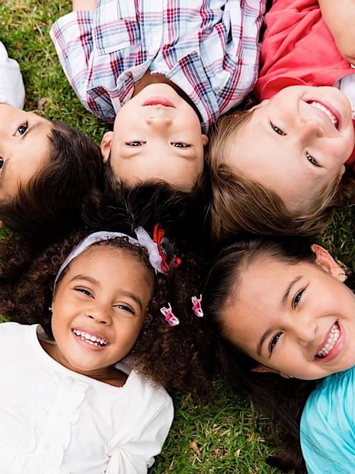 A group of kids laying down on the ground at Mundo Imperial