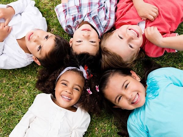 A group of kids laying down on the ground at Mundo Imperial