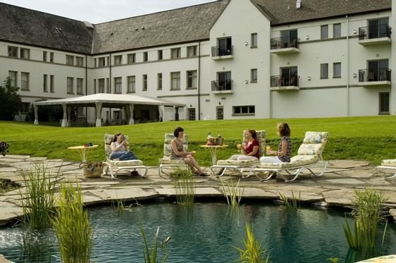 Ladies on the sunbeds by the pond at La Tourelle Hotel and Spa