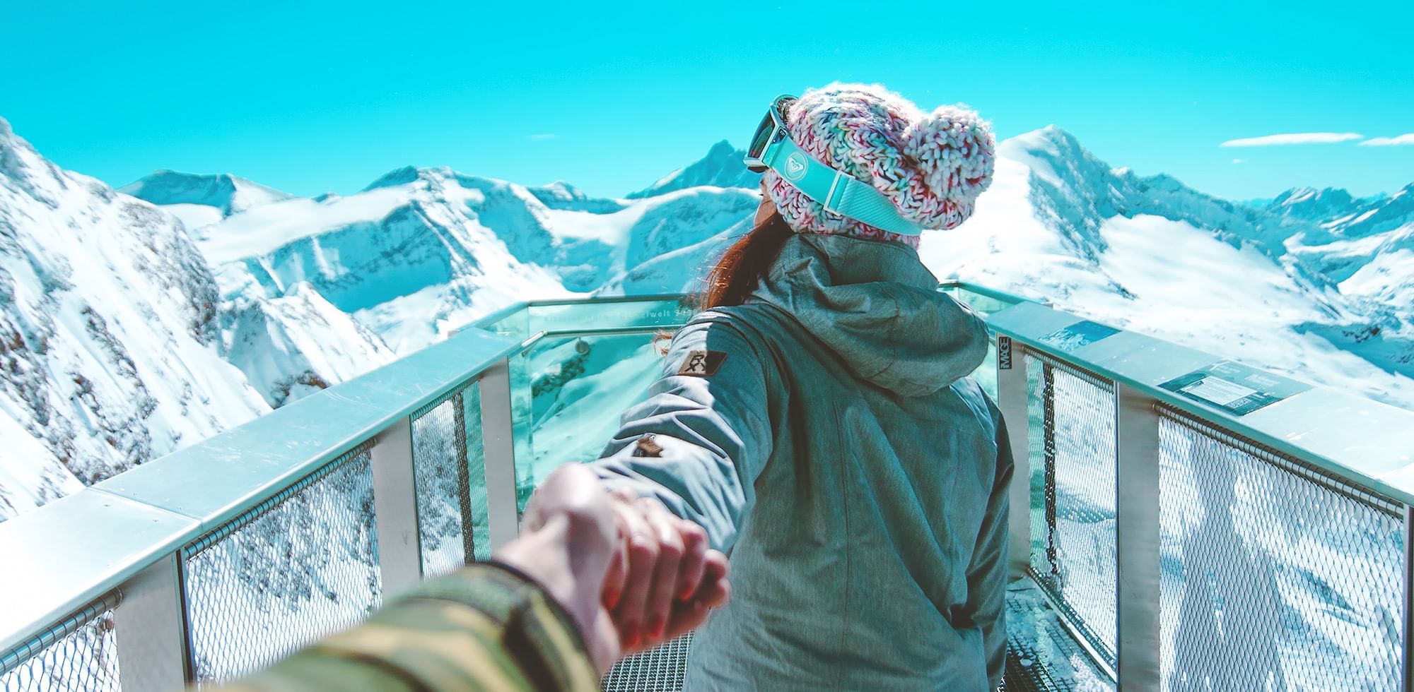 women walking on a viewing deck looking at glaciers