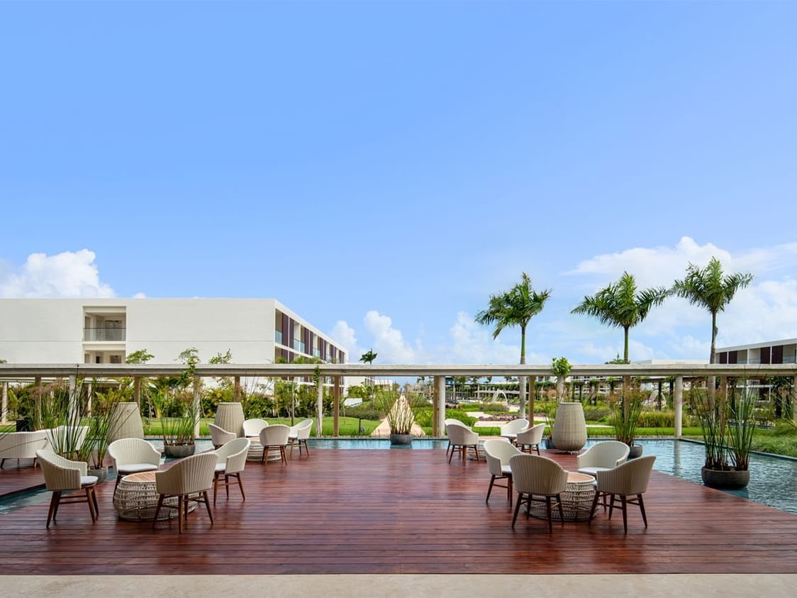 Outdoor sitting area with pool at La Coleccion Resorts