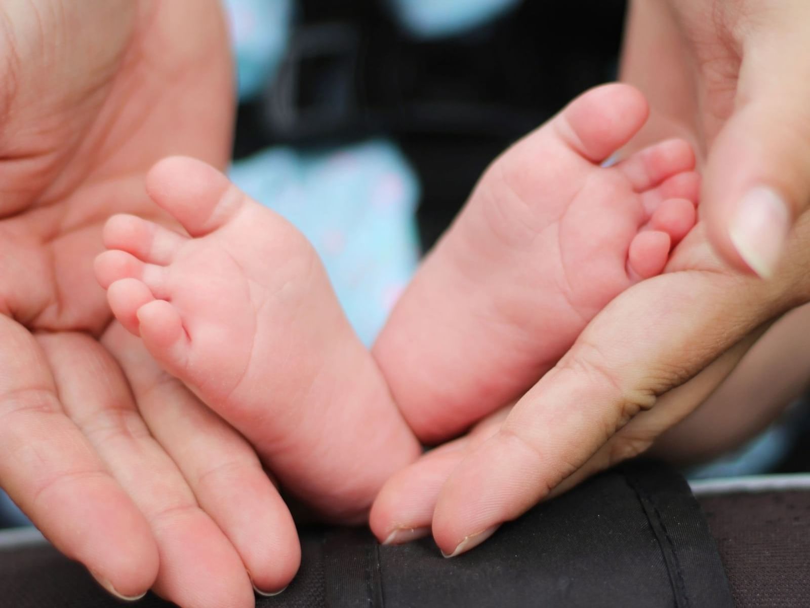 Close-up of a baby's feet on mothers hand at Park Hotel Hong Kong