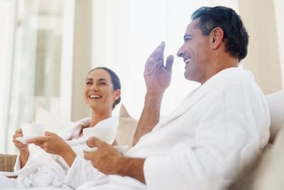 A couple smiling while having a cup of tea at Sunseeker Resort