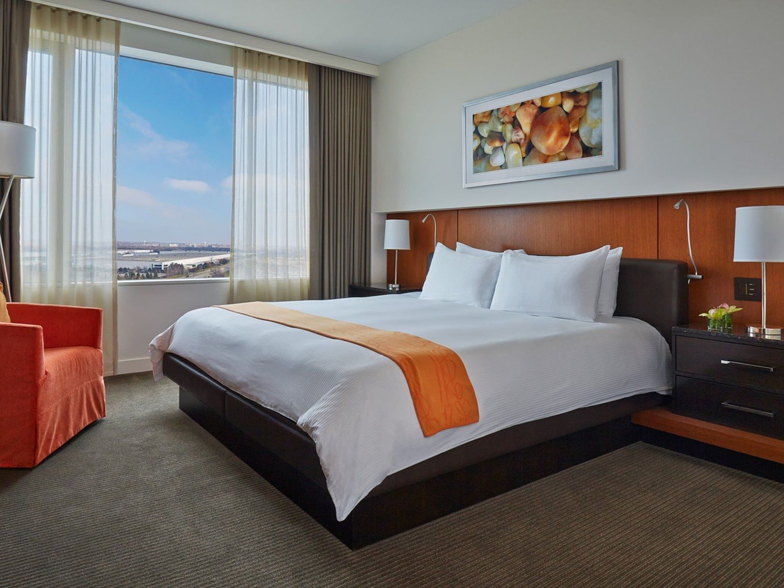 a bed and chair in a hotel room