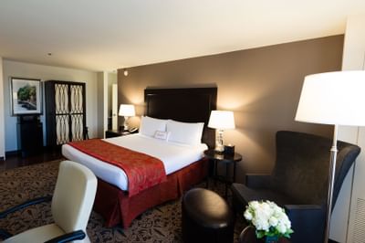 bed in carpeted room with flowers