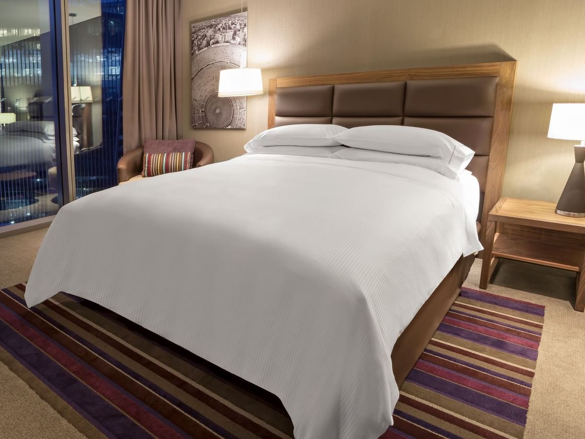 Two bedside lamps with carpeted floor in Deluxe Room, 1 King at Fiesta Americana