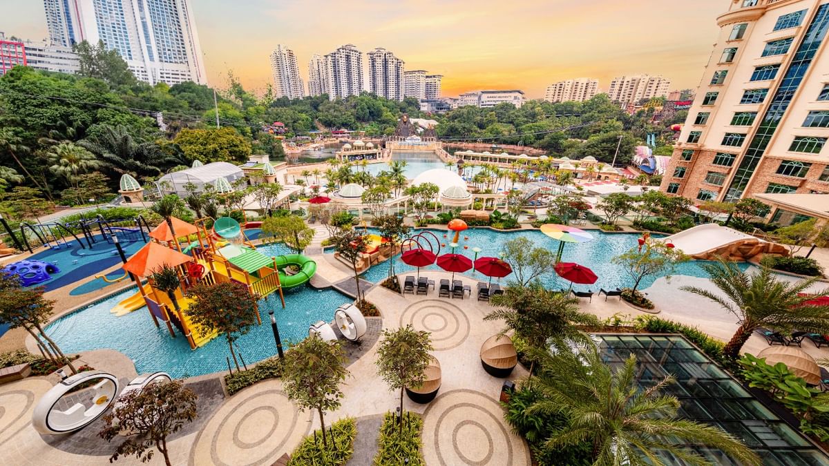 Sunset view from Waterventure Terrace, showcasing pools, slides, and lush landscaping at Sunway Resort
