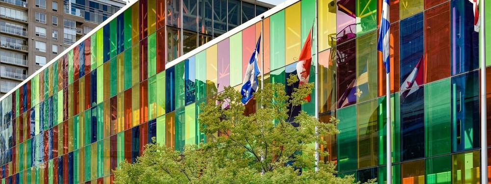 Colorful rainbow glass facade of the convention center near Warwick Le Crystal Montreal