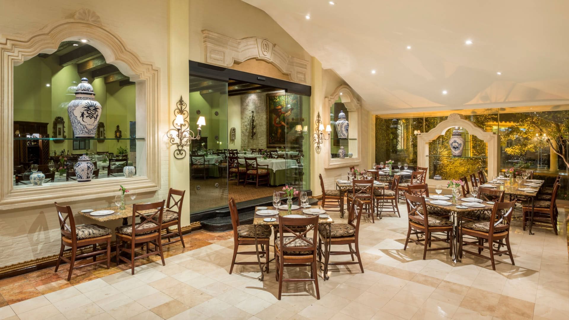 Bright and spacious dining hall with large windows and traditional decor at the Quinta Real Saltillo