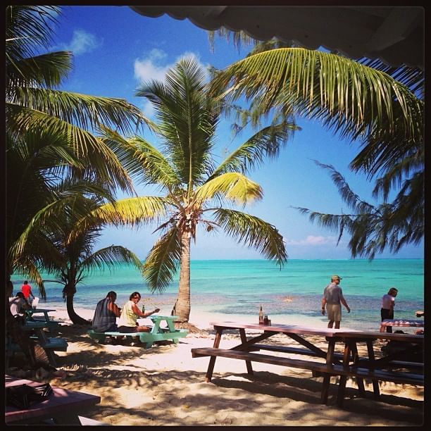 People on a beach near The Somerset on Grace Bay