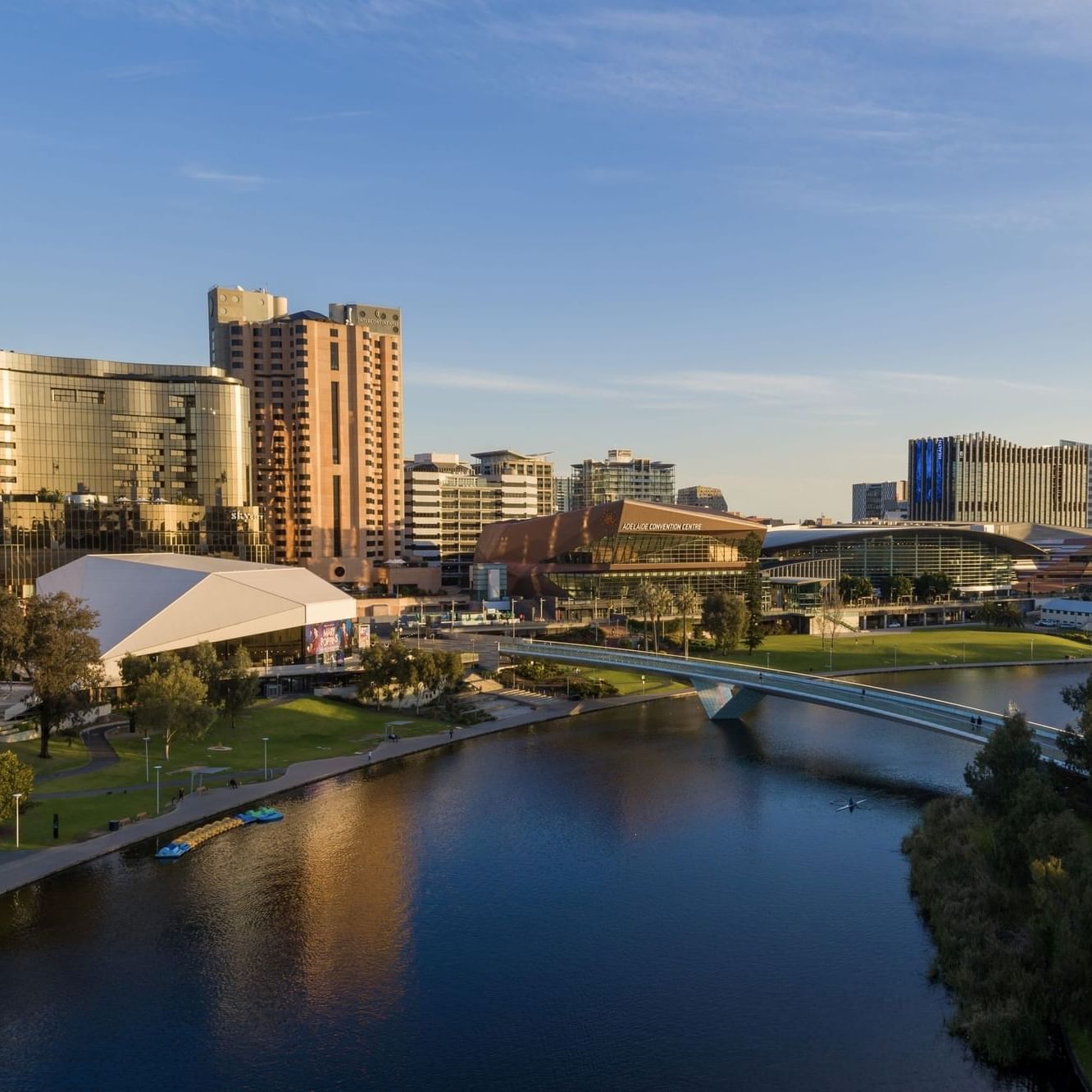 Aerial view of a cityscape with a river and bridge showcasing Australia Day celebrations.