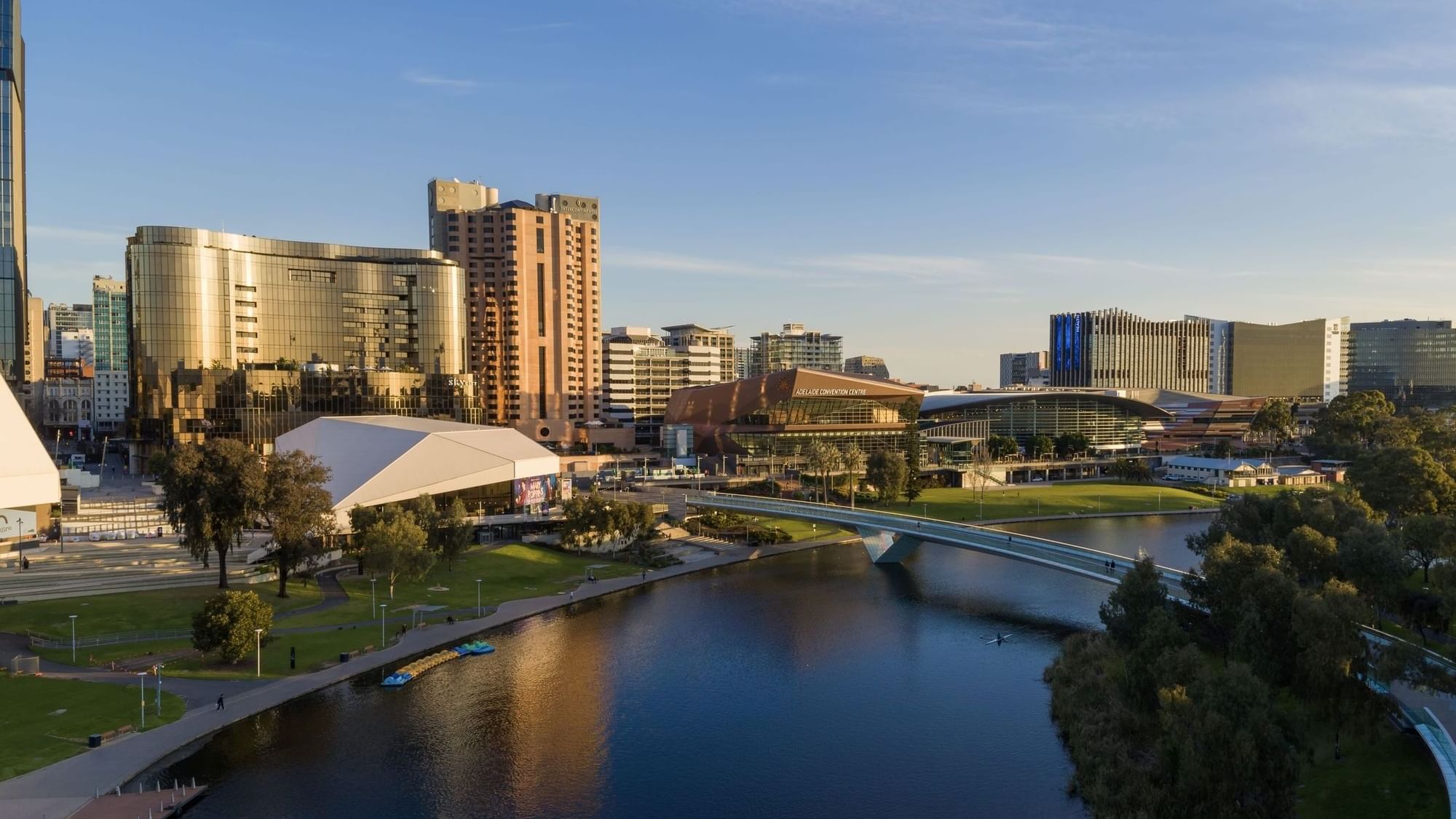 Aerial view of a cityscape with a river and bridge showcasing Australia Day celebrations.